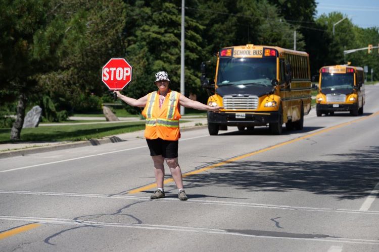 Image of crossing guard holding up a stop sign