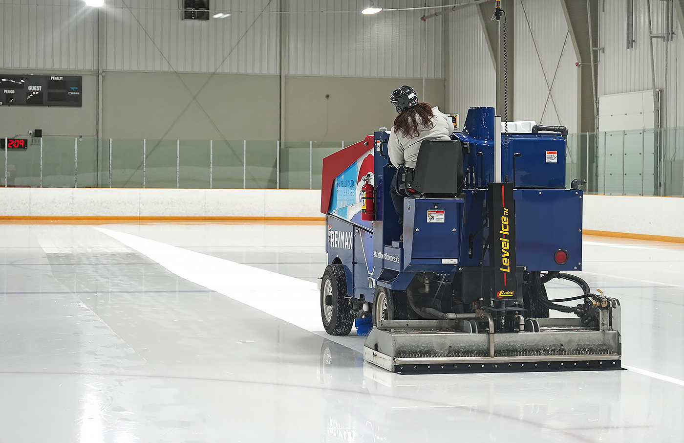 ice resurfacer flooding the ice at a hockey arena