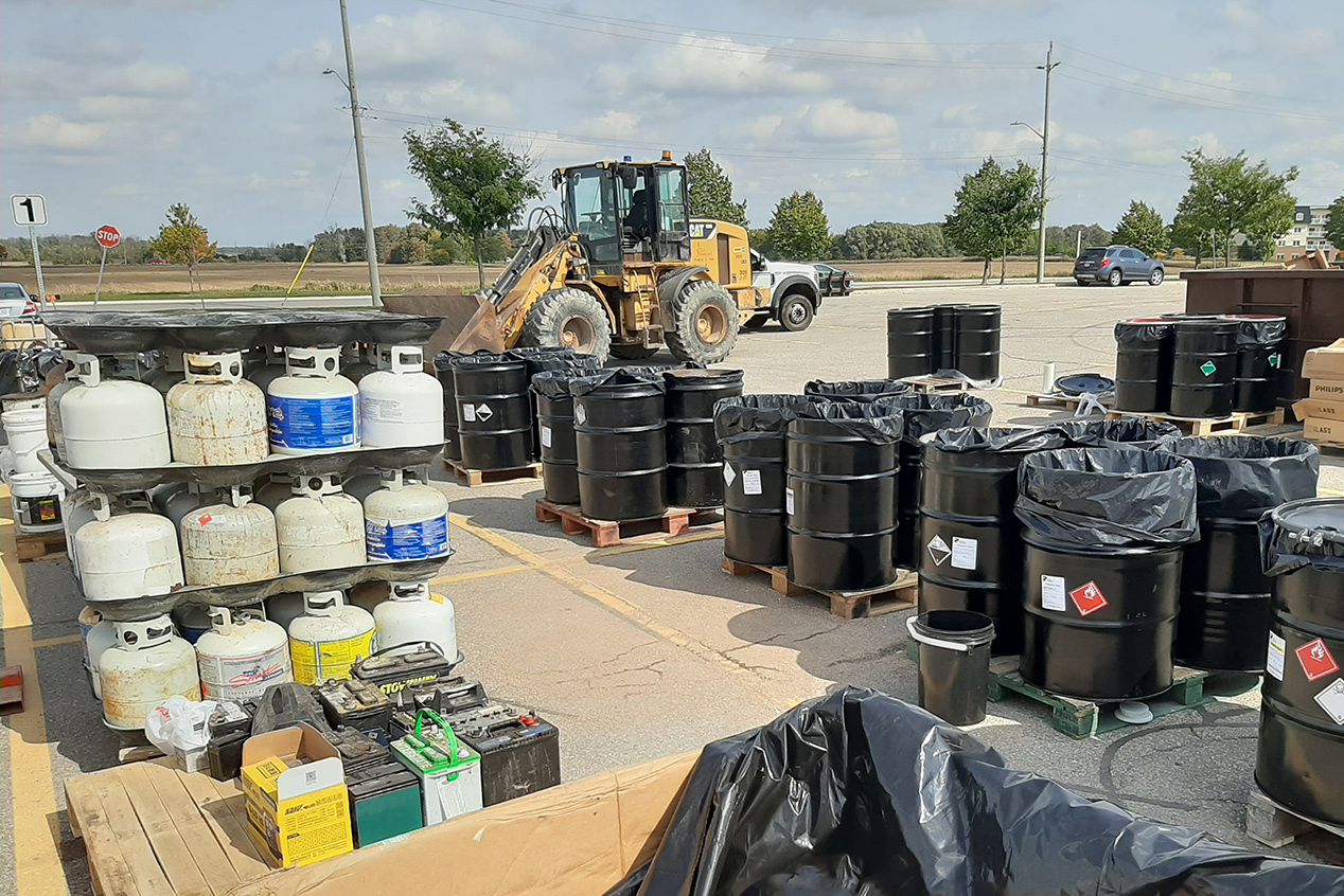 hazardous waste in cans in boxes, with loader