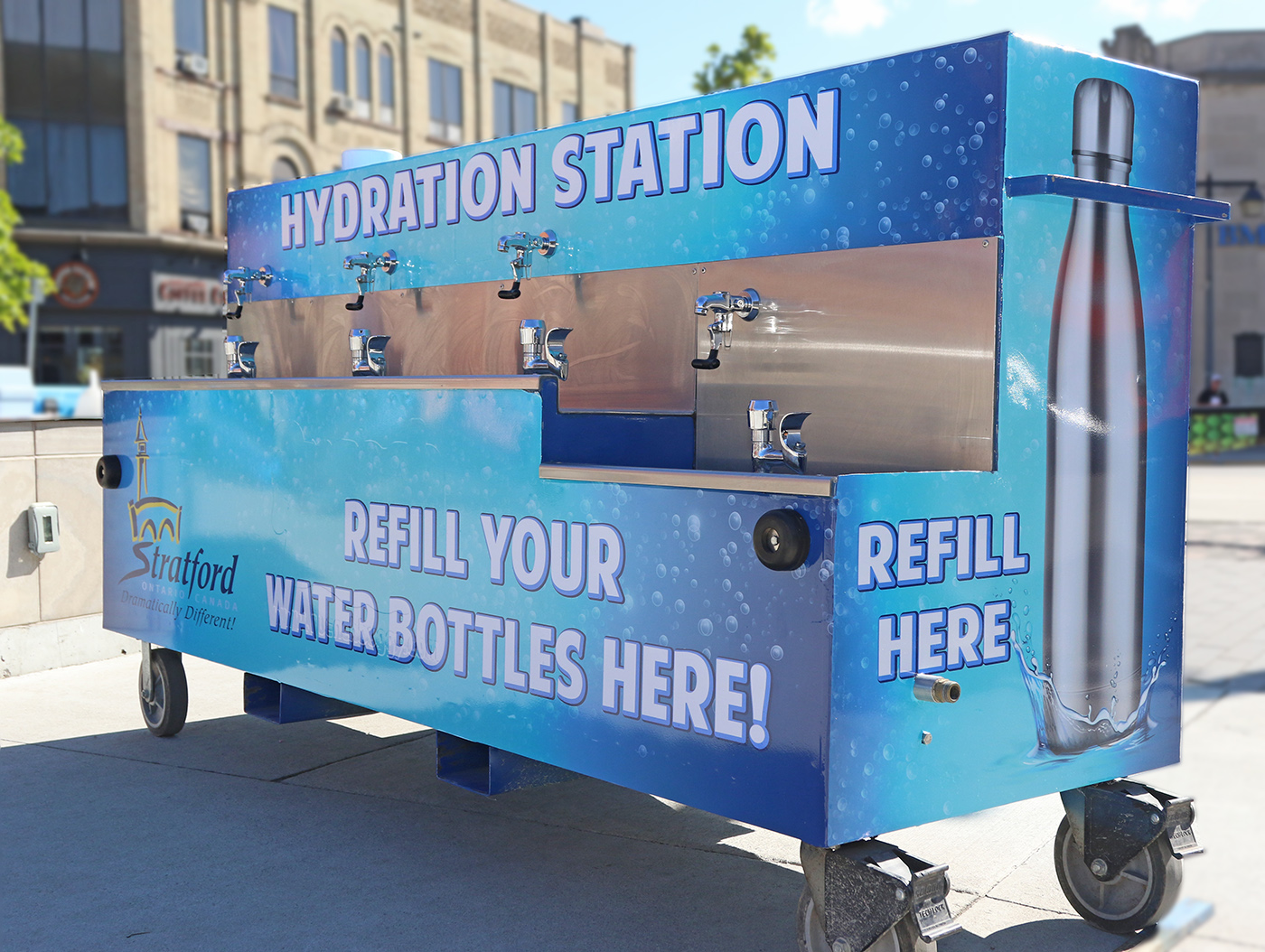 Image of the hydration station. The station is on wheels and has five water filling spouts.