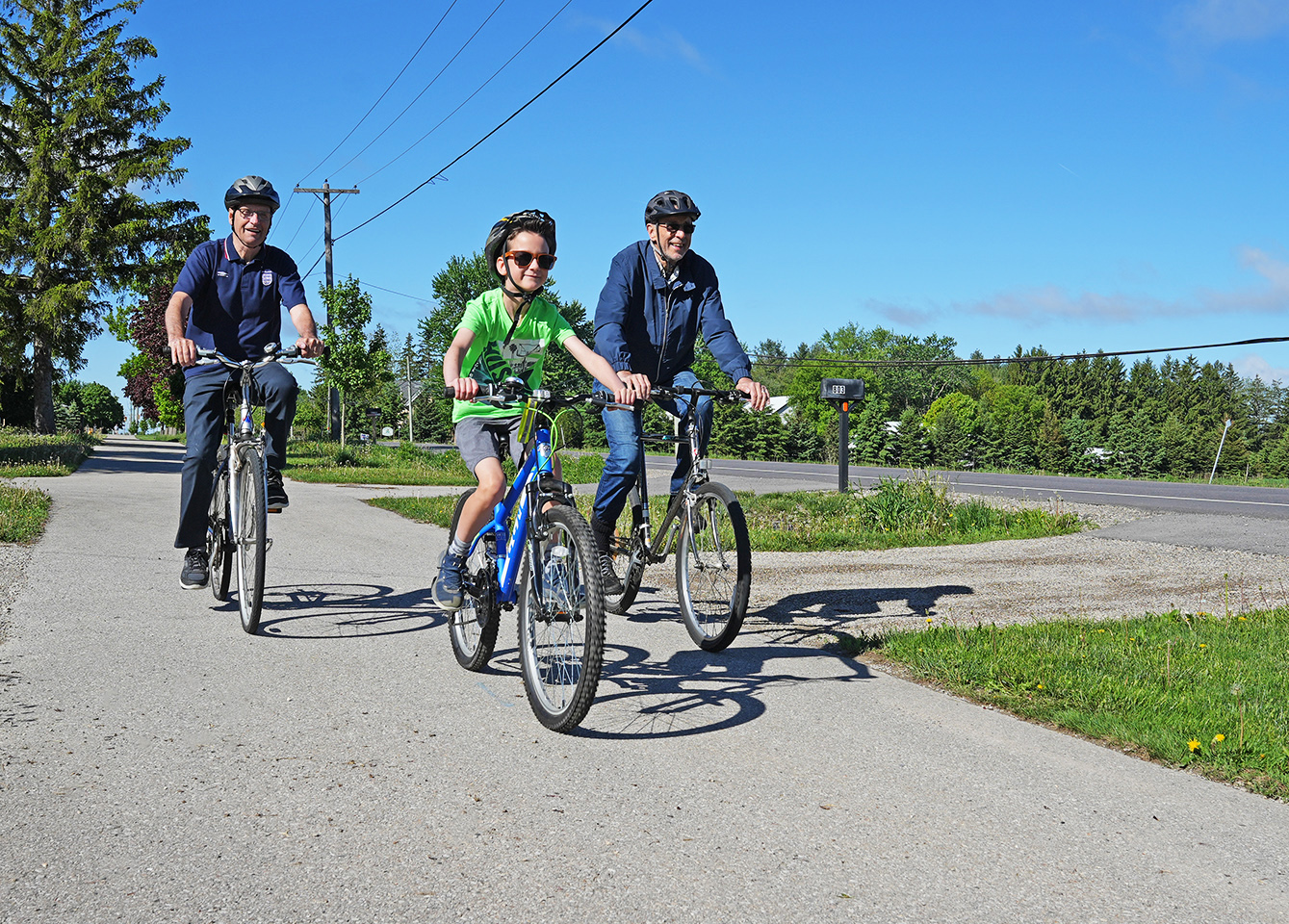 Bike Month 2022 Three cyclists riding on asphalt pathway