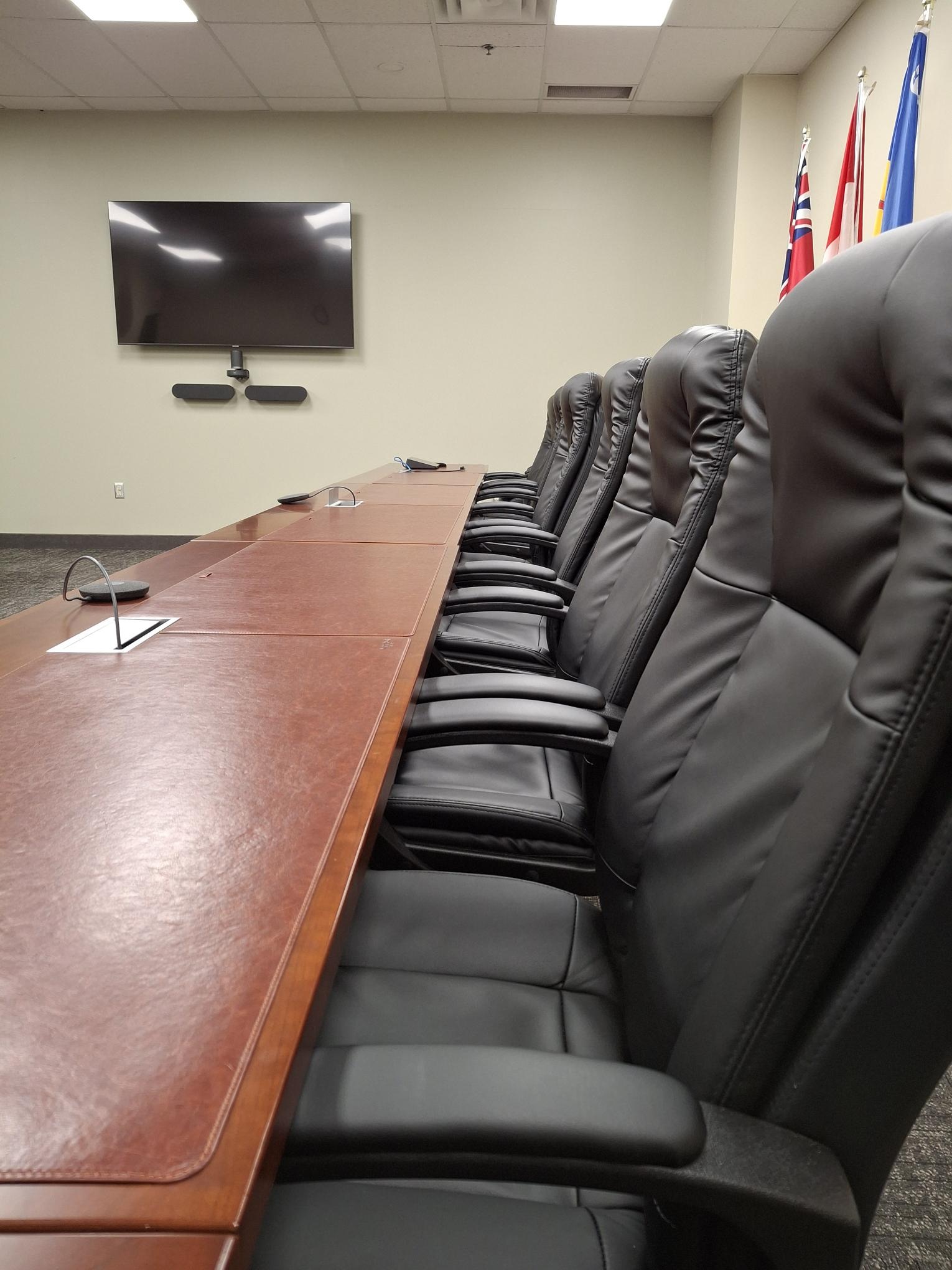 A table and row of boardroom chairs.
