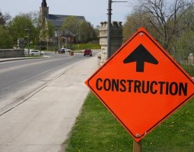 Construction sign with road and bridge