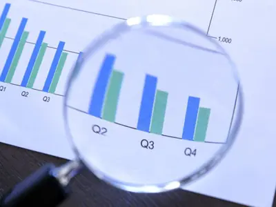 Magnifying glass looking at report