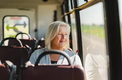 woman driving a bus, smiling