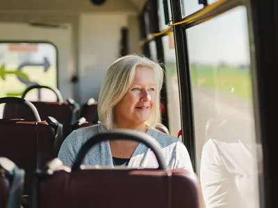 woman driving a bus, smiling