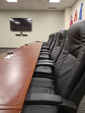 A table and row of boardroom chairs.