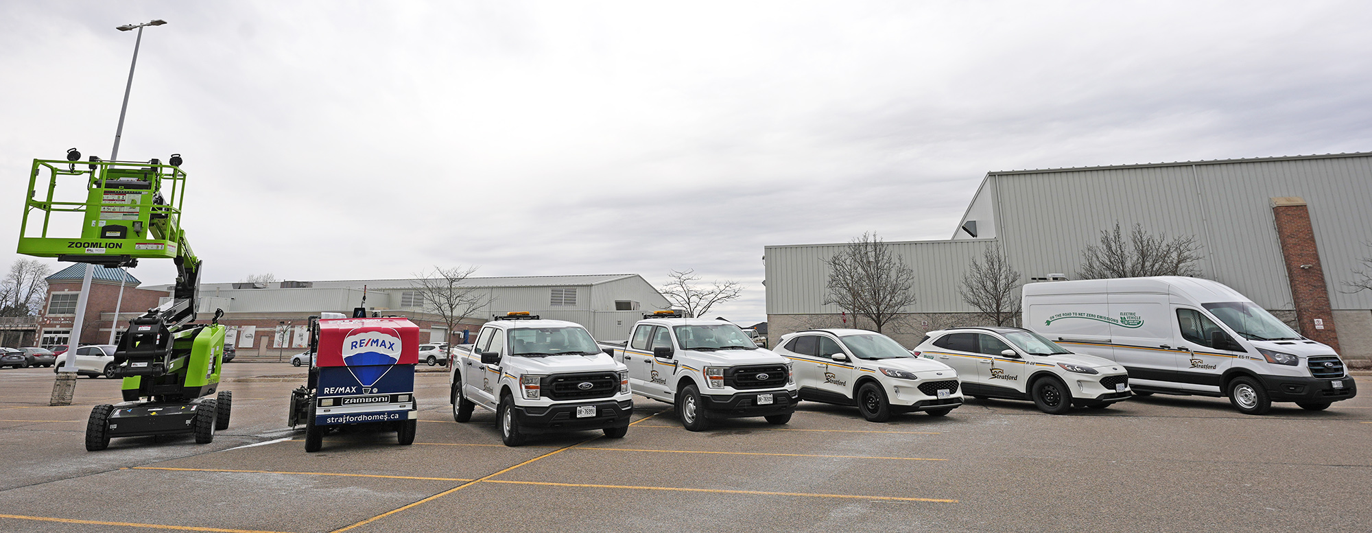 A row of elecctric or hybrid vehicles in a parking lot
