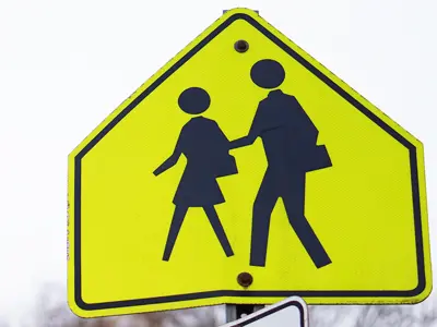 Yellow and black school crossing sign