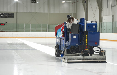 Ice resurfacer flooding the ice at a hockey arena