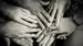 Many sets of hands joining together