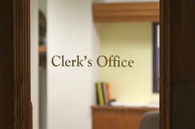 Glass door with text that reads Clerk's Office