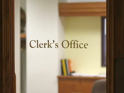 Glass door with text that reads Clerk's Office